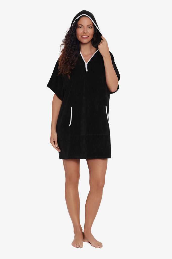 Woman wearing a pull over swim cover up with white trim detail and the hood up