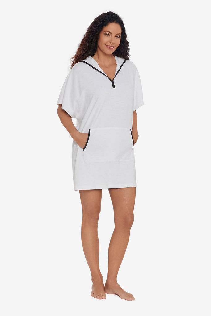 Woman wearing a pull over swim cover up with black trim detail