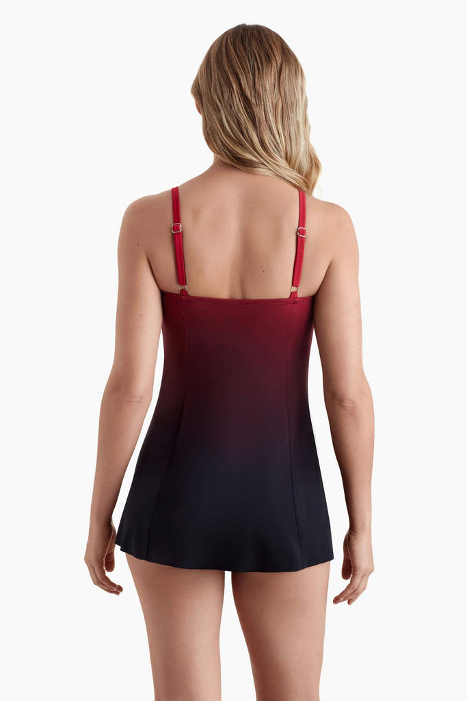 Woman faced away wearing a red into black ombre swim dress