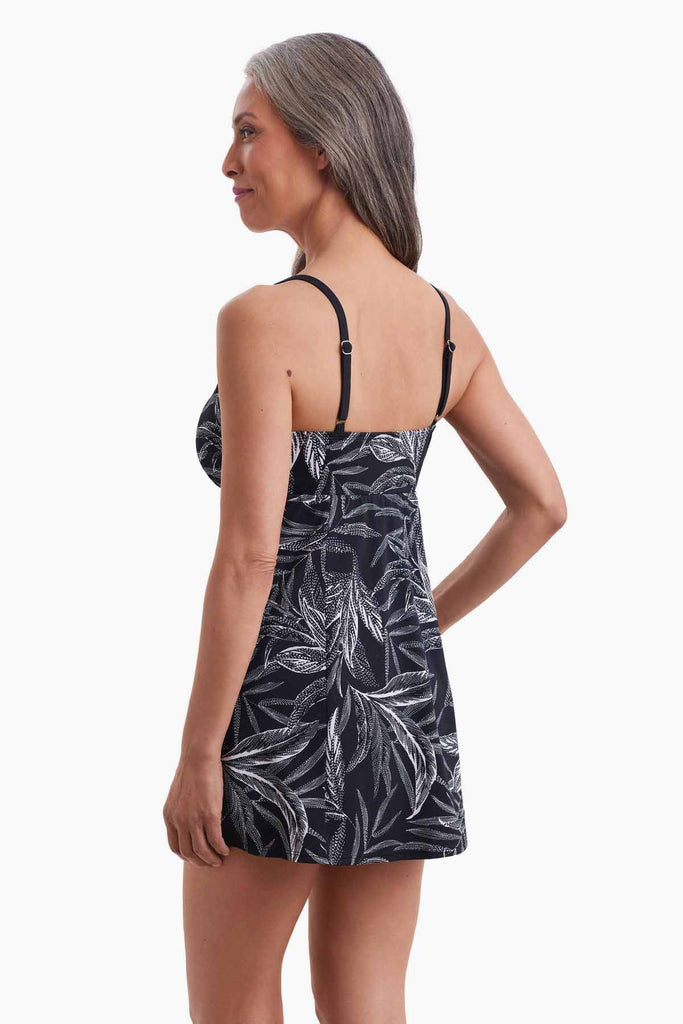 Woman turned to the left to show the side detail of the swim dress