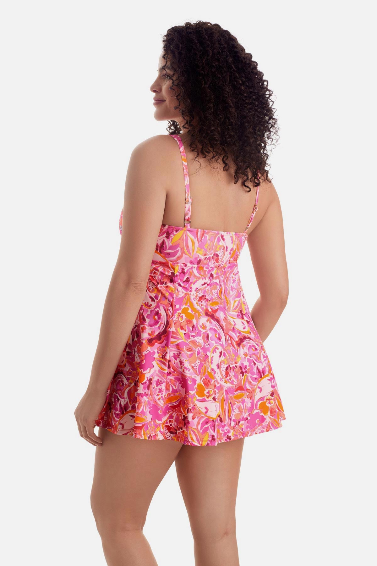 Woman turned left wearing a pink floral printed swim dress