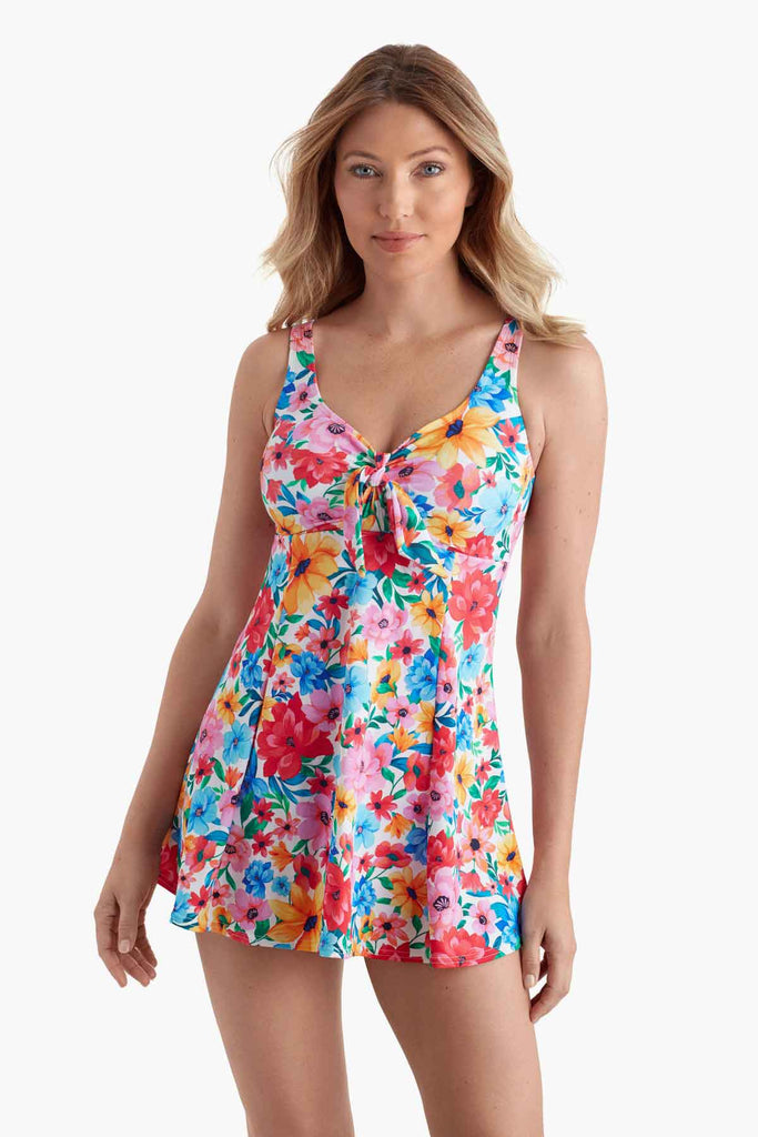 Woman wearing a swim dress with a multicolored floral print