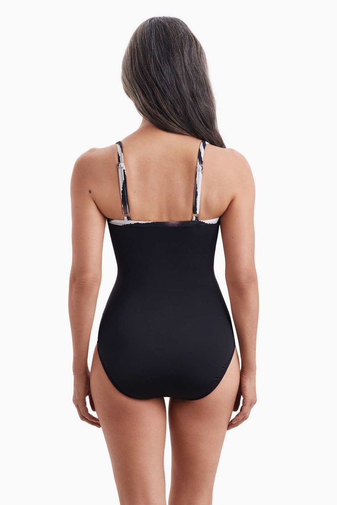 Woman faced away wearing a one-piece swimsuit