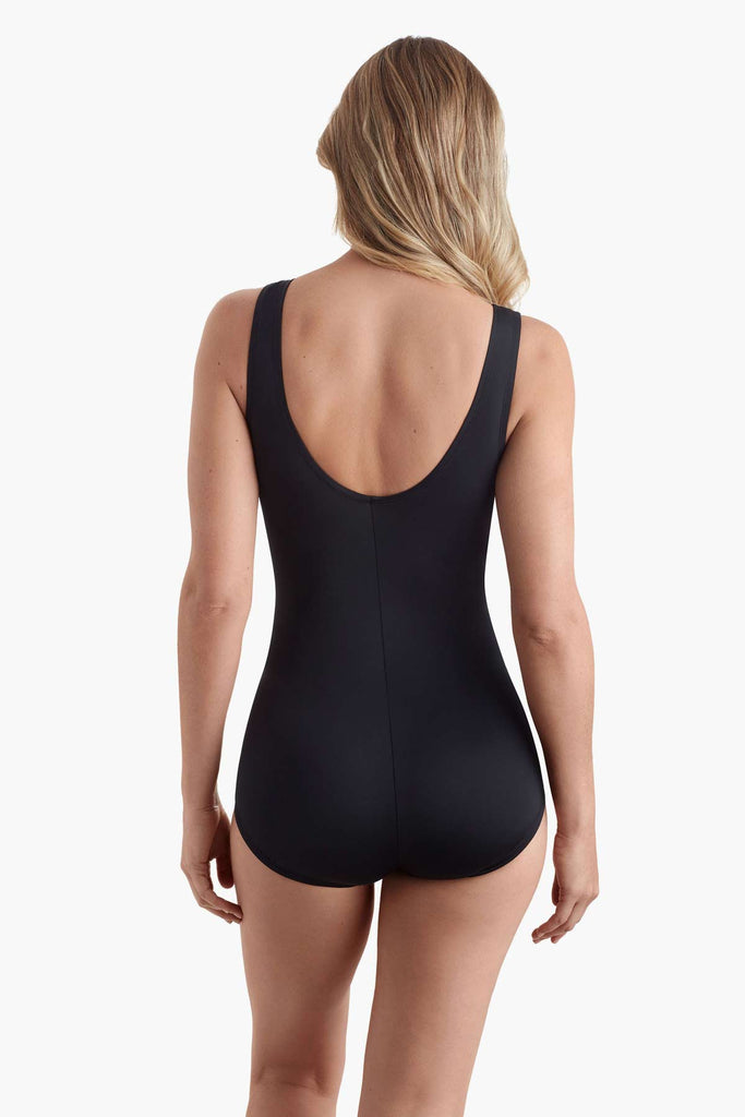 Woman faced away wearing a one-piece swimsuit 