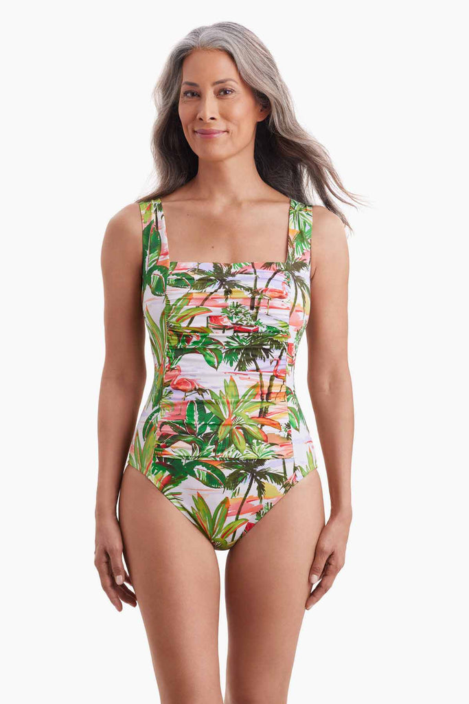 Woman wearing a multicolored one-piece swimsuit with shirring on the front