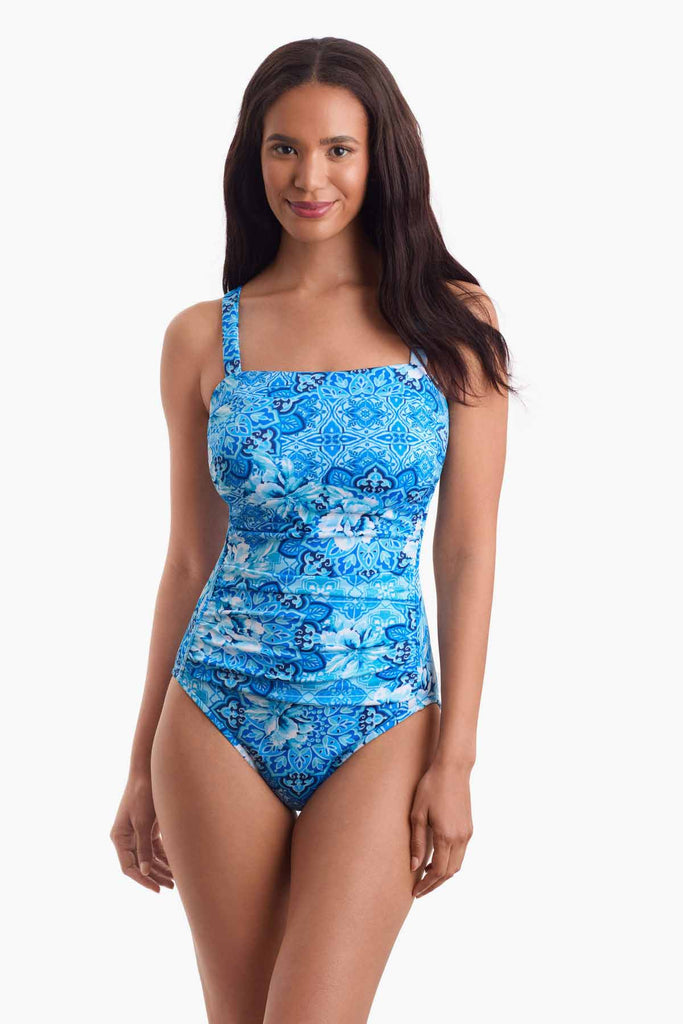 Woman wearing a blue abstract printed one-piece swimsuit 