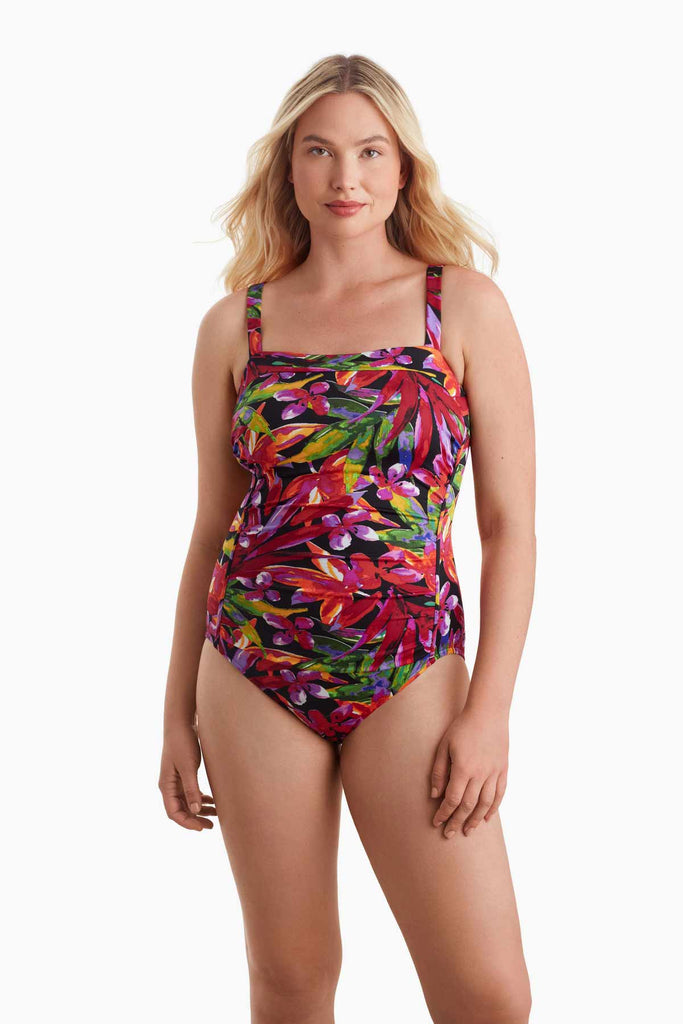 Woman wearing a multicolored one-piece swimsuit with a floral print