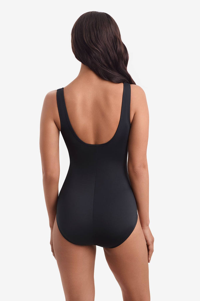 Woman turned away to show off back of one-piece swimsuit