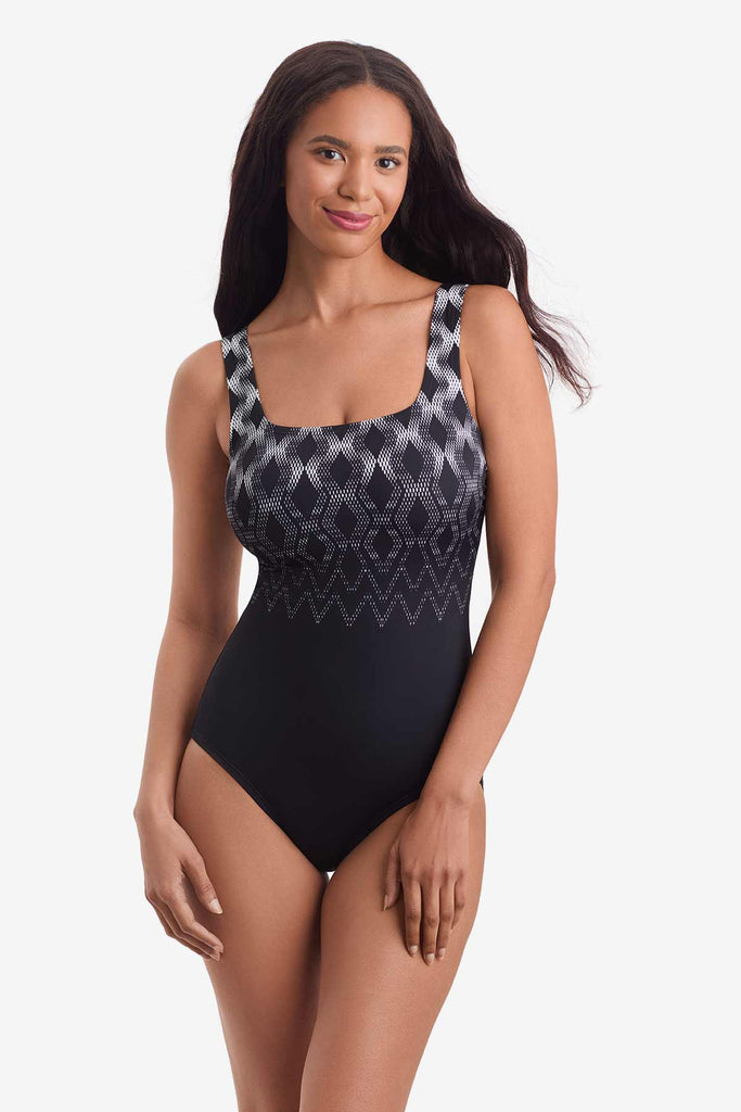 Woman wearing a one-piece swimsuit with a geometric pattern