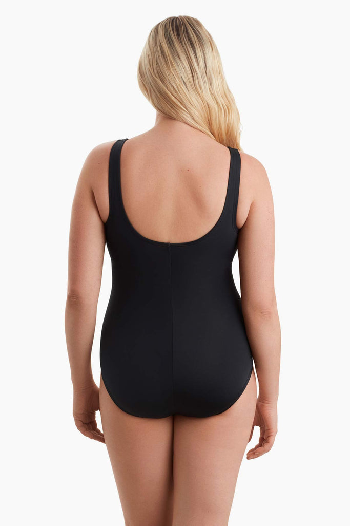 Woman facing away showing scoop back on one-piece swimsuit