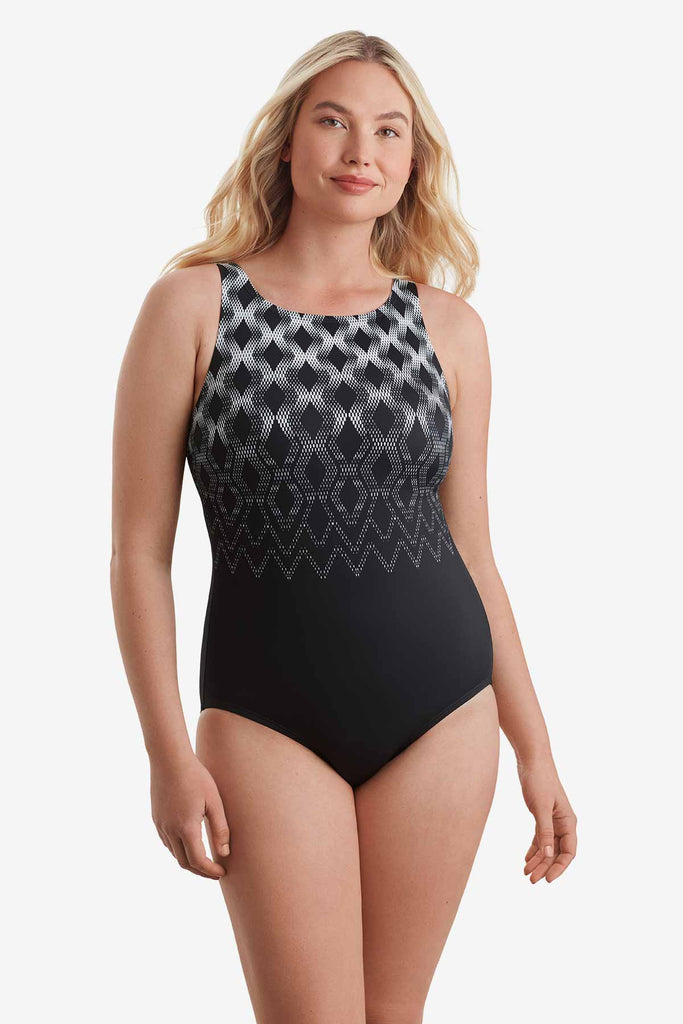 Woman wearing a one-piece swimsuit with a geometric pattern