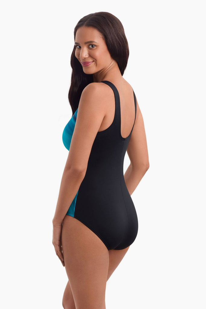 Woman facing left to show detail of one-piece swimsuit