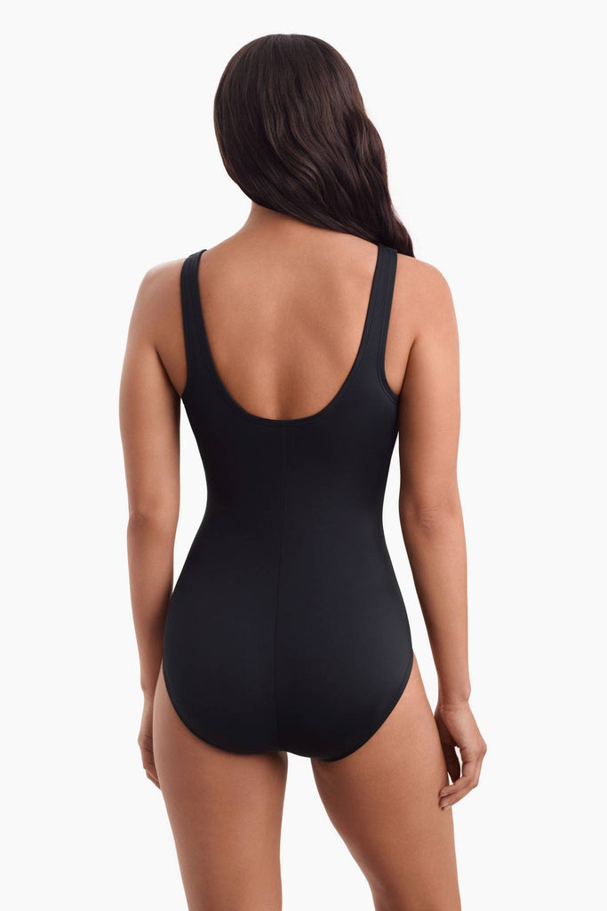 Woman facing away wearing a one-piece swimsuit