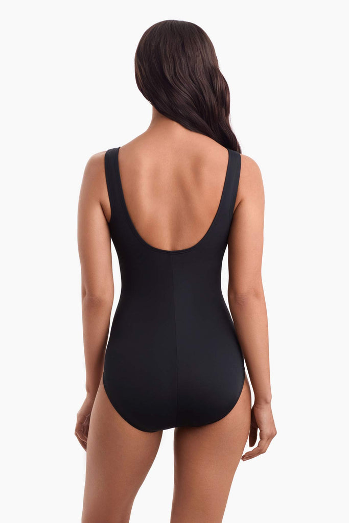 Woman facing away wearing a one-piece swimsuit