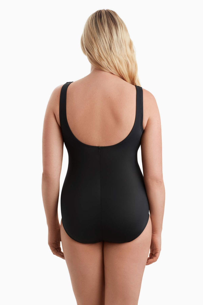 Woman faced away wearing a one-piece swimsuit 