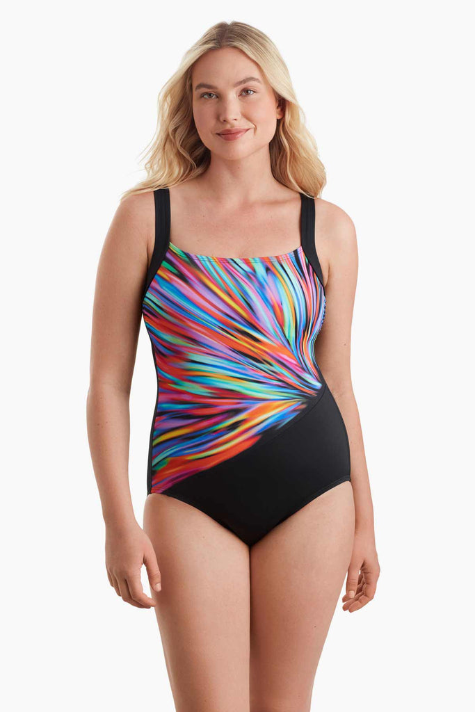 Woman wearing a one-piece swimsuit with a multicolored pattern