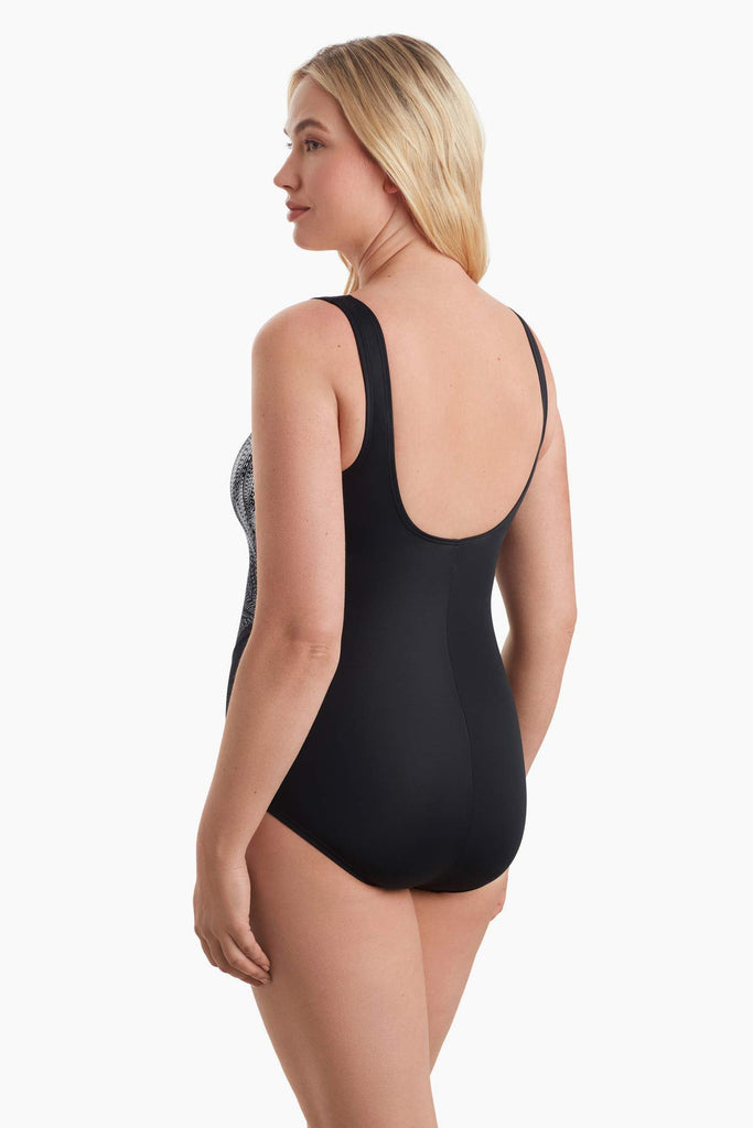 Woman faced left to show detail of one piece swimsuit