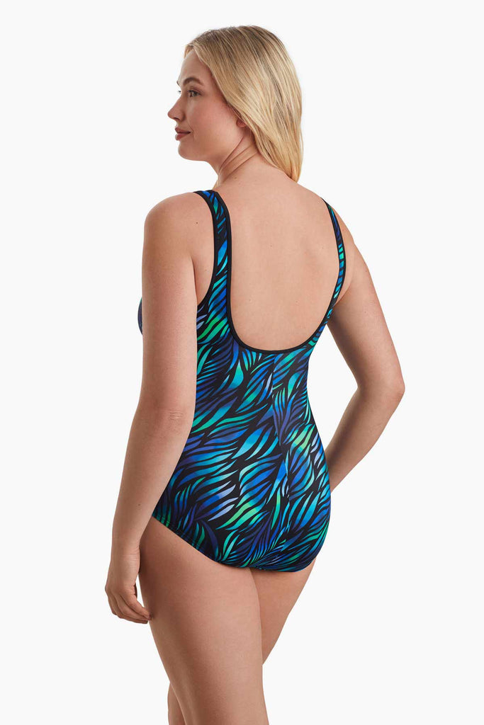 Woman facing to the left to show detail of blue and green swimsuit