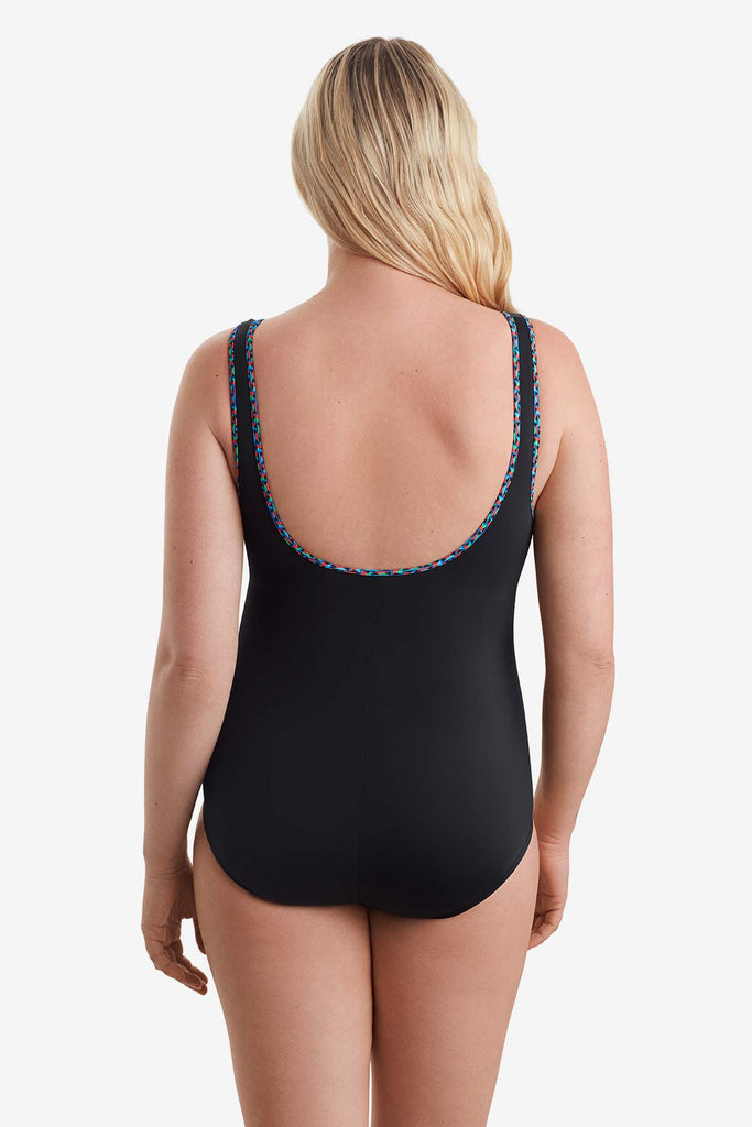 Woman faced away to show trim detail on the back of one-piece swimsuit