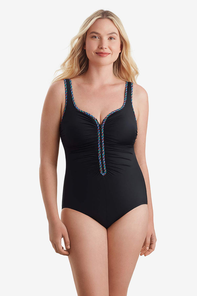 Woman wearing a one-piece swimsuit with multicolor trim on the front