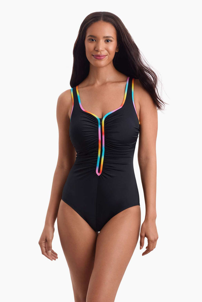 Woman wearing a one-piece swimsuit with rainbow trim down the front