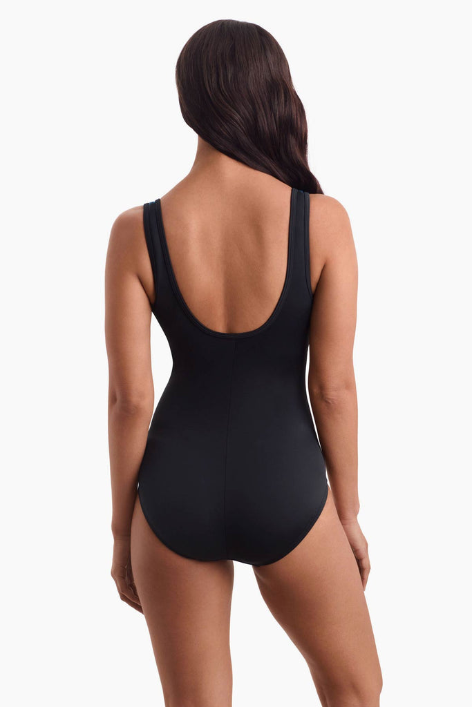 Woman turned away wearing a one-piece swimsuit that is all black in the back