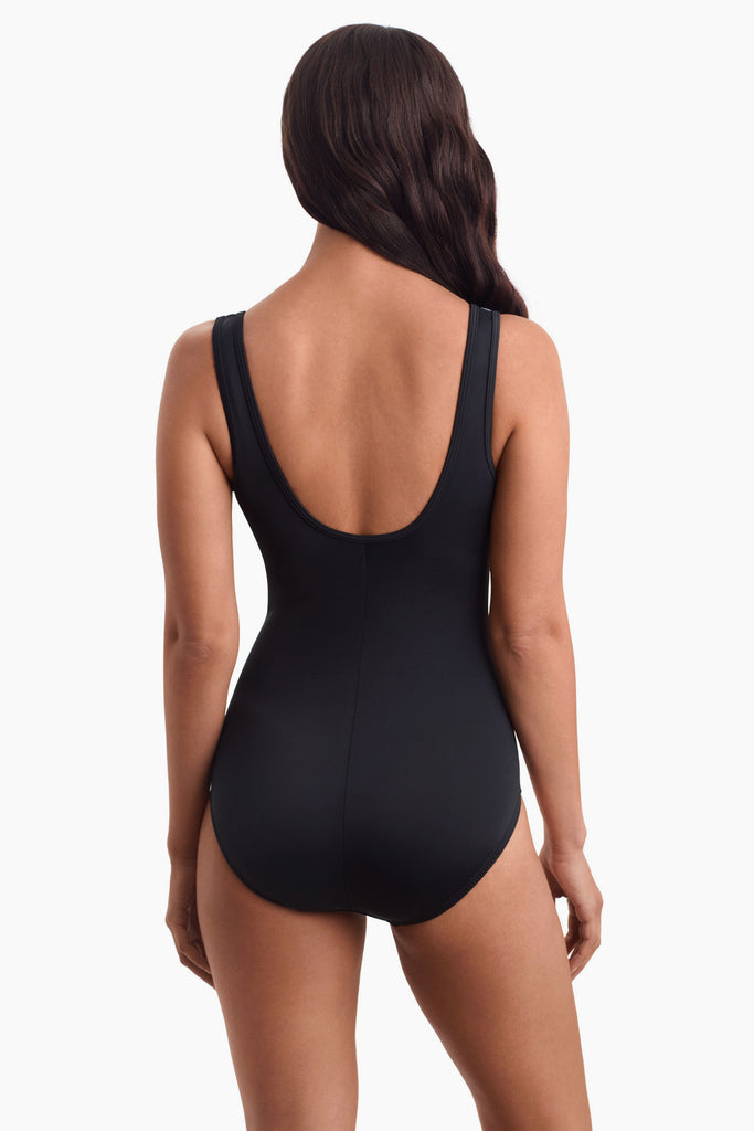 Woman acing away to show scoop back of swimsuit