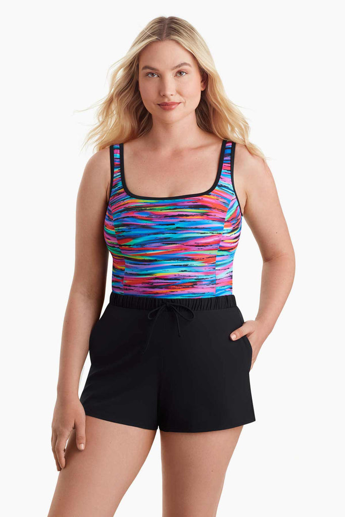 Woman wearing a one-piece swimsuit with a multicolor pattern