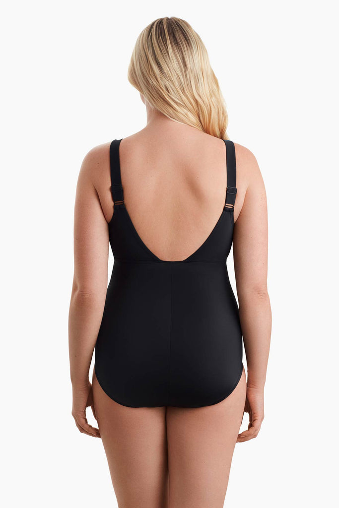 Woman facing away to show detail of one-piece swimsuit