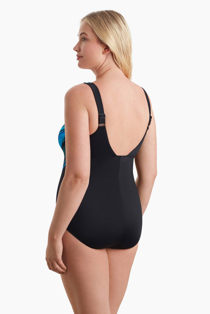 Woman facing left to show detail of one-piece swimsuit