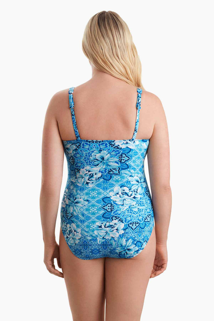 Woman facing away to show off back detail of one-piece swimsuit