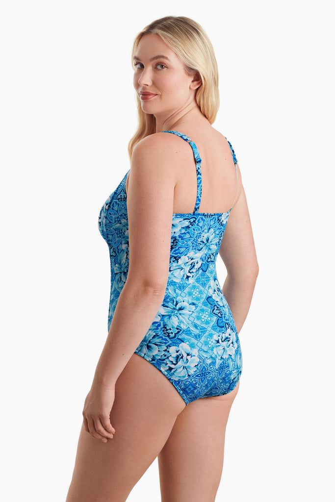 Woman turned left to show detail of blue one-piece swimsuit