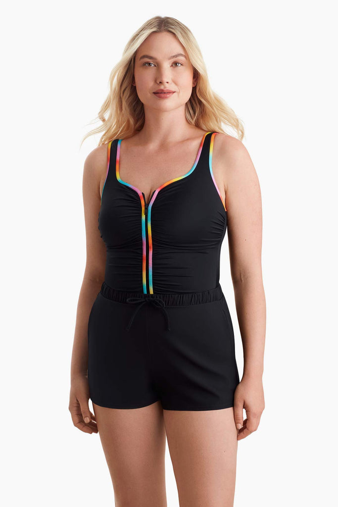 Woman wearing a one-piece swimsuit with rainbow trim on the front