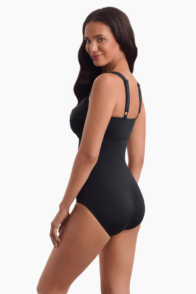 Woman facing left to show off detail o one-piece swimsuit