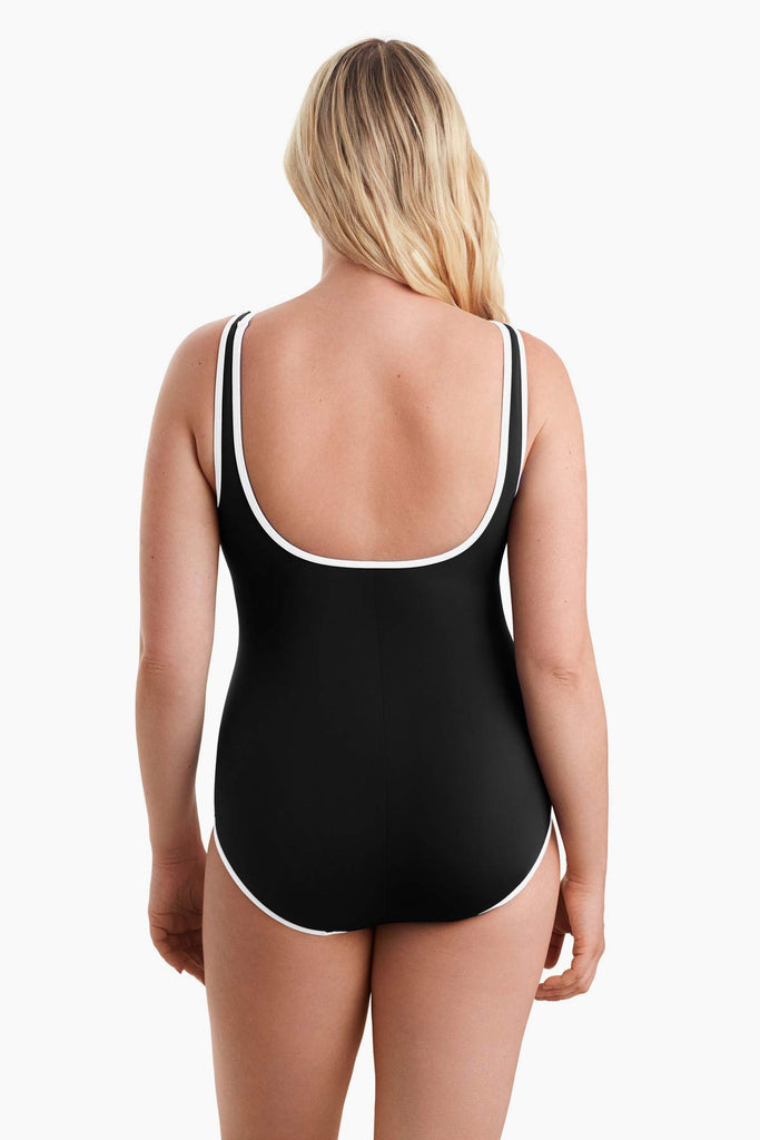 Woman facing away to show back detail of one-piece swimsuit