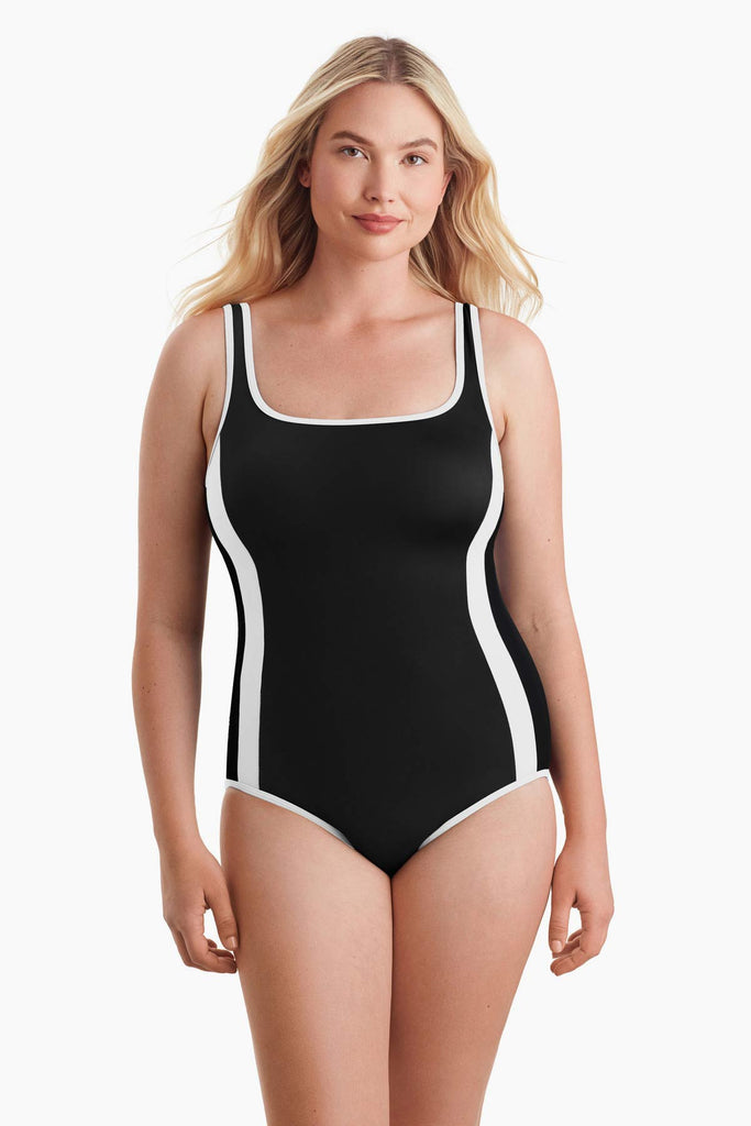 Woman wearing a one-piece swimsuit with white stripes on both sides