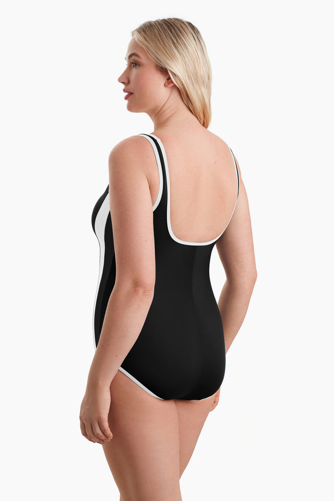 Woman turned left to show detail of one-piece swimsuit