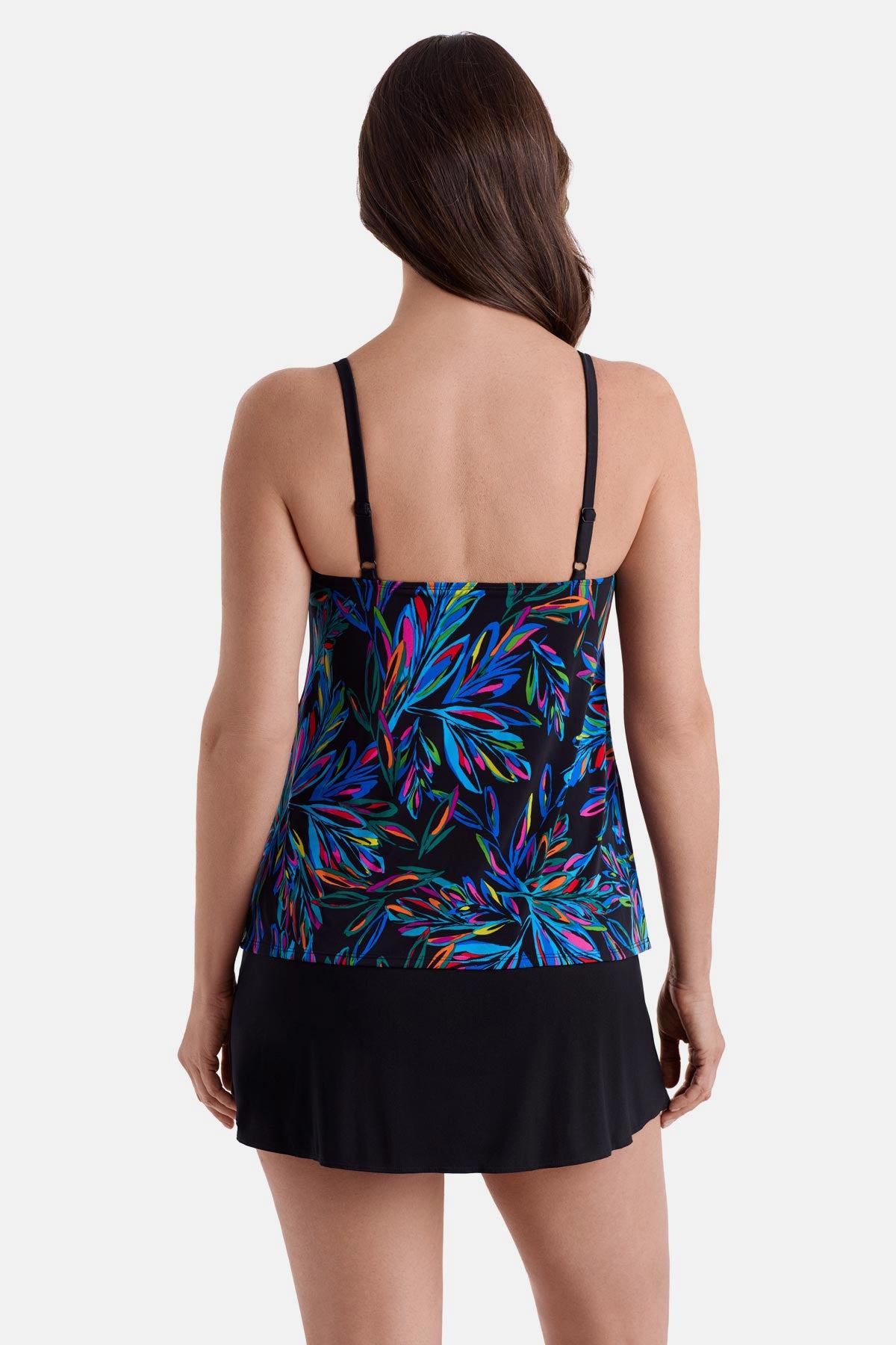 Woman turned away wearing an abstract rainbow printed faux ruffle skirtini swimsuit
