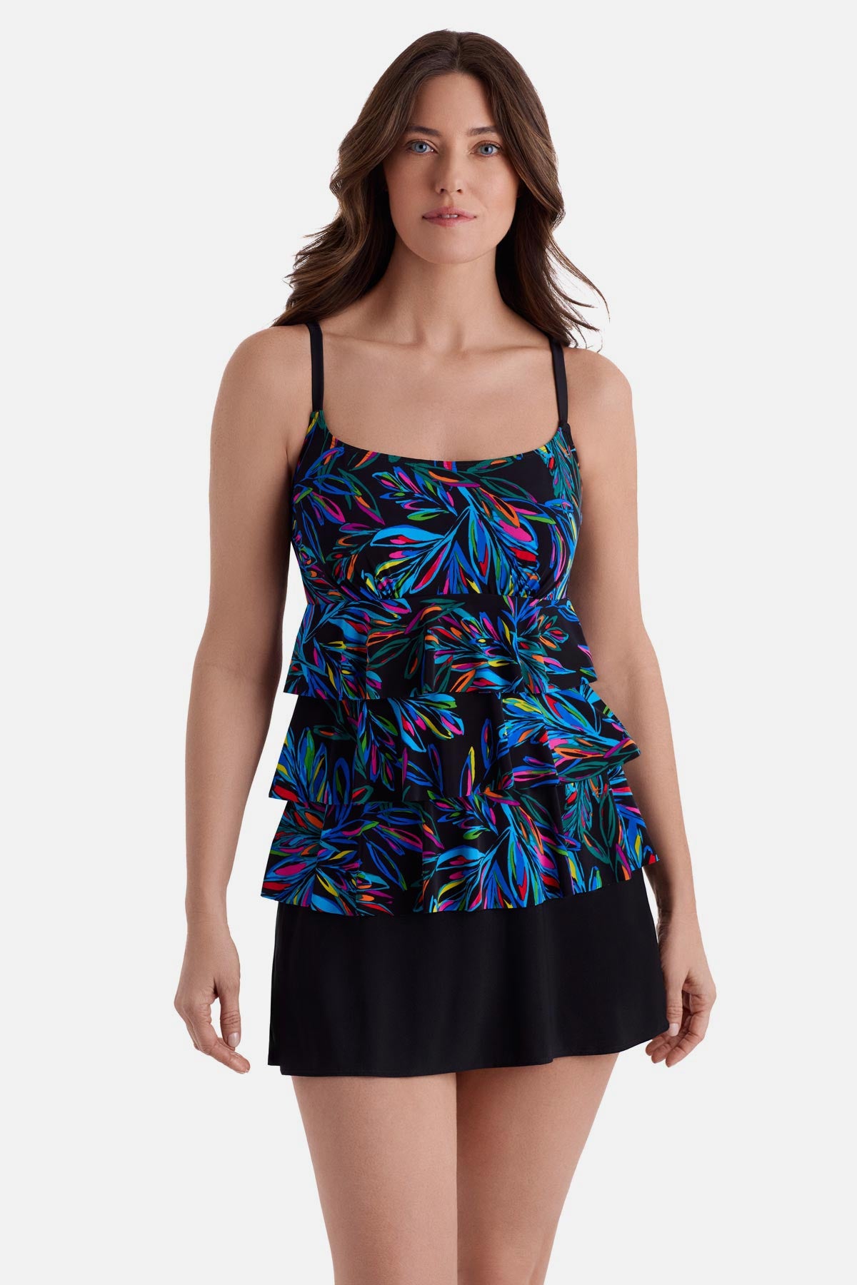 Woman wearing an abstract rainbow printed faux ruffle skirtini swimsuit