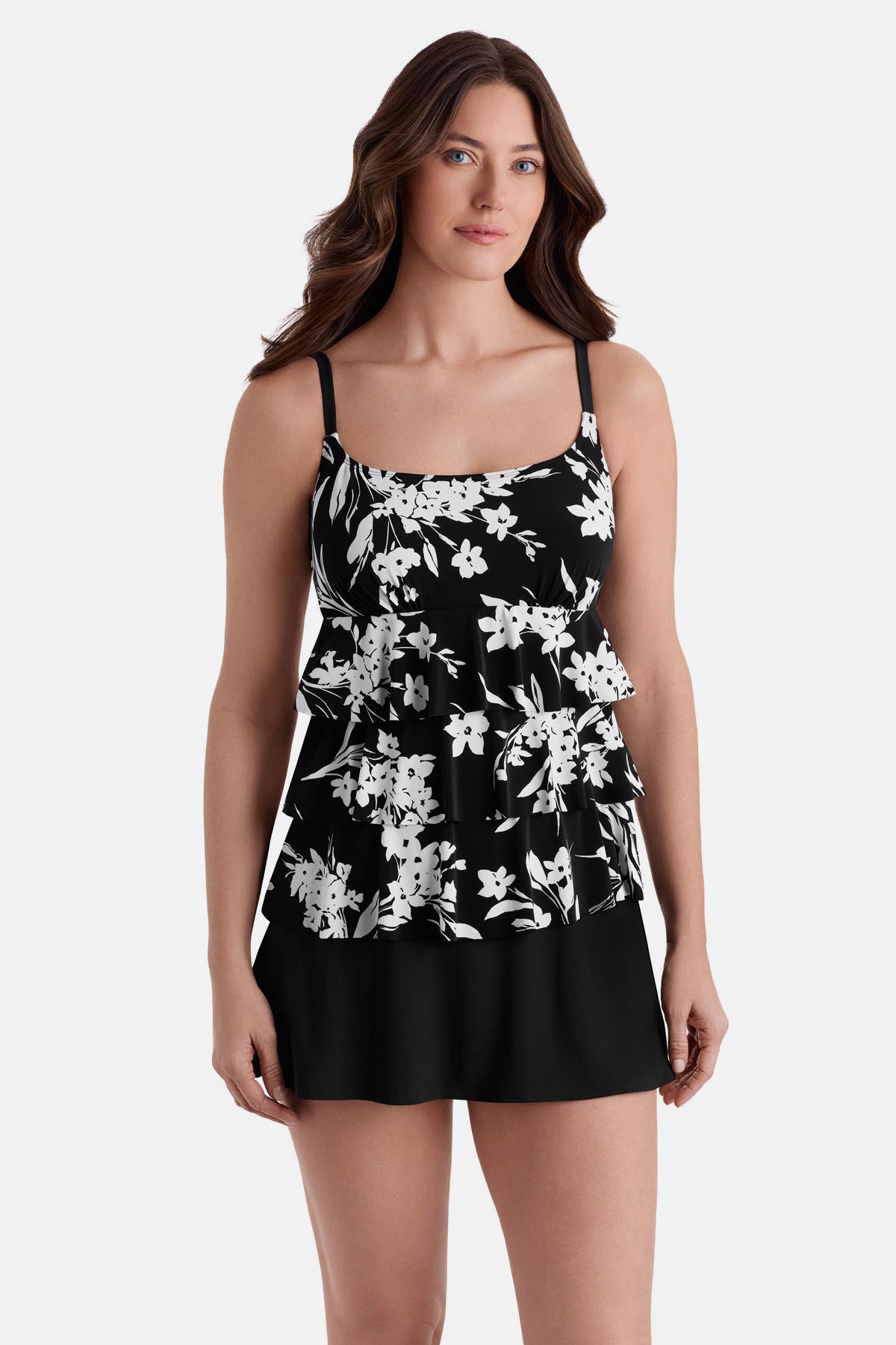 Woman wearing a black and white floral printed ruffle skirtini swimsuit