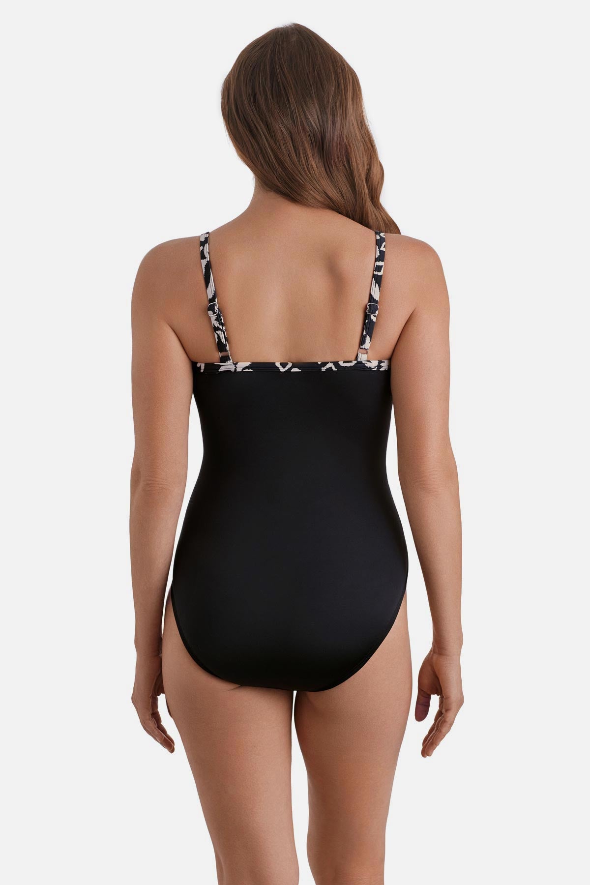 Woman turned away wearing a black and white palm tree printed one-piece swimsuit