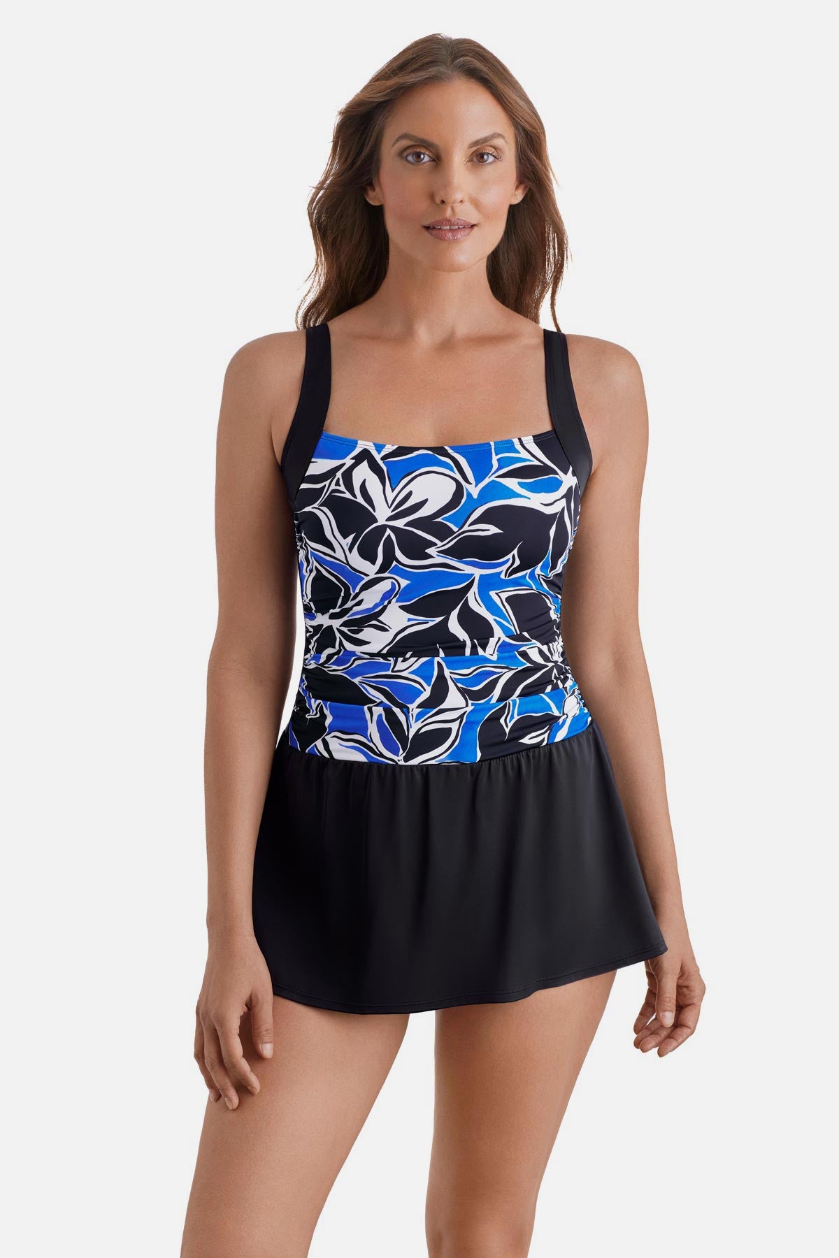 Woman wearing a black, blue and white floral printed skater swim dress with black skirted bottom
