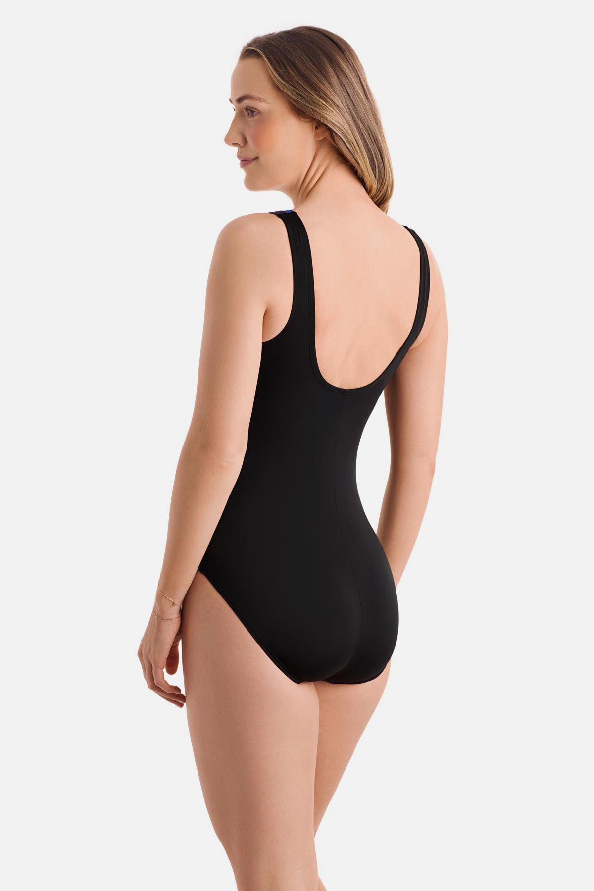 Woman turned left wearing a blue radial print one-piece swimsuit