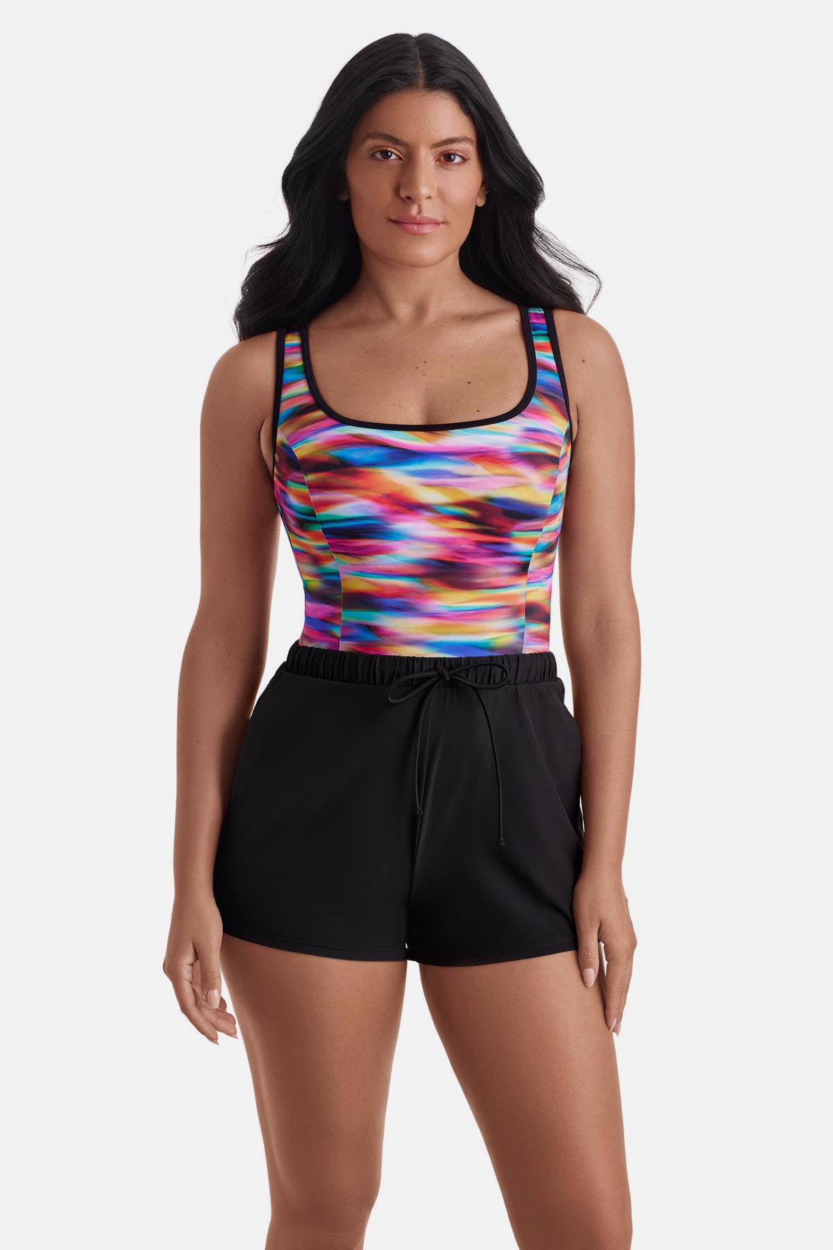 Woman wearing a rainbow tie dye one-piece swim romper